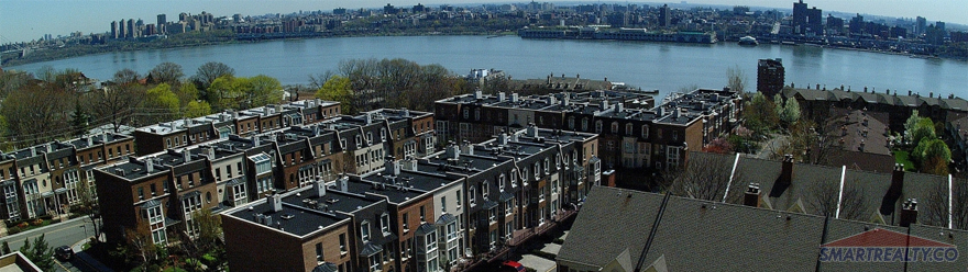 "The breathtaking views of the Hudson River NYC skyline behind Kensington Park townhouses."